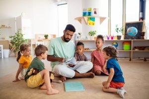 erzieher liest kindern etwas vor